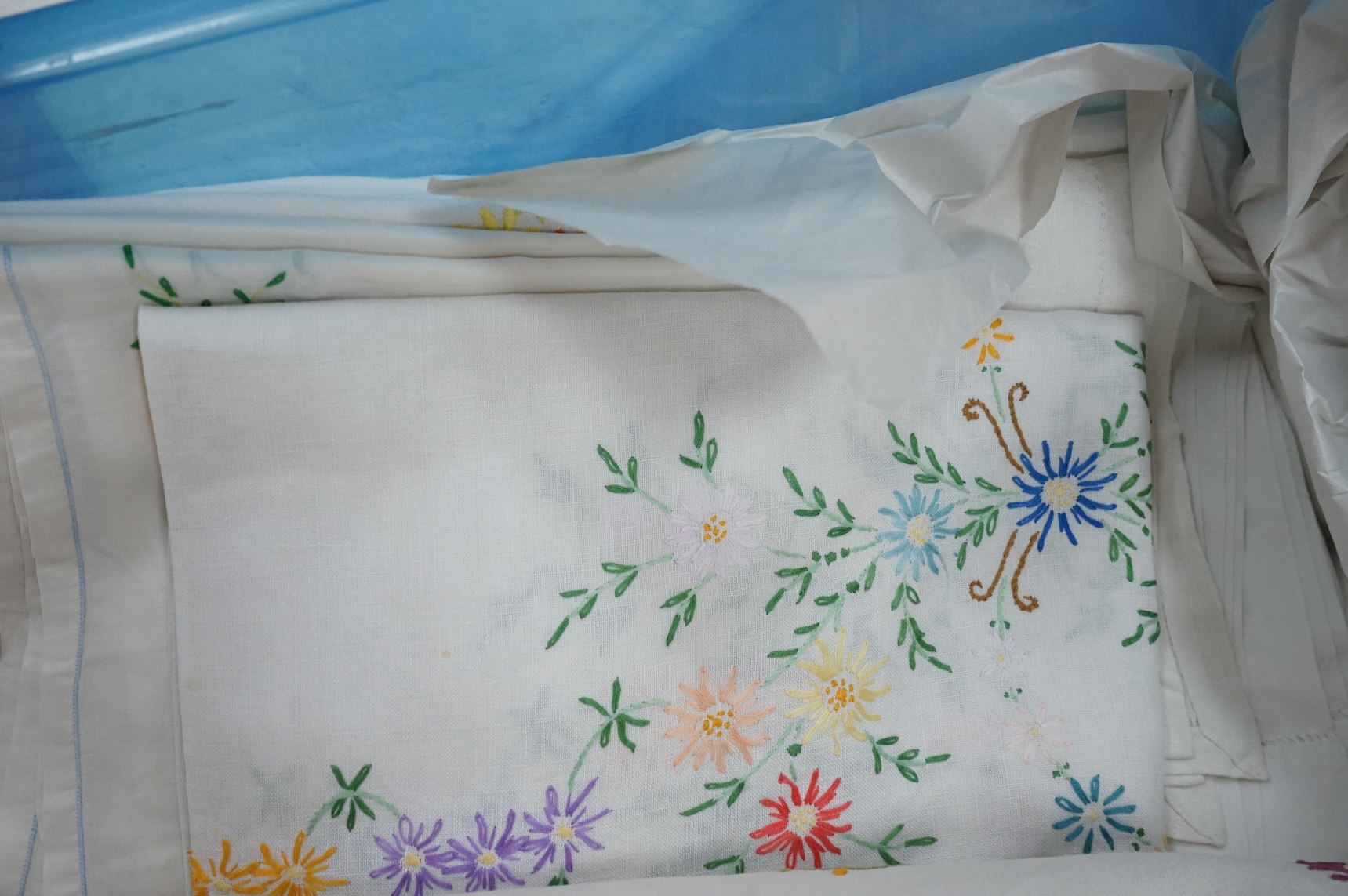 A collection of early 20th century and later crochet, cut work and drawn thread table linens and a large embroidered table cloth